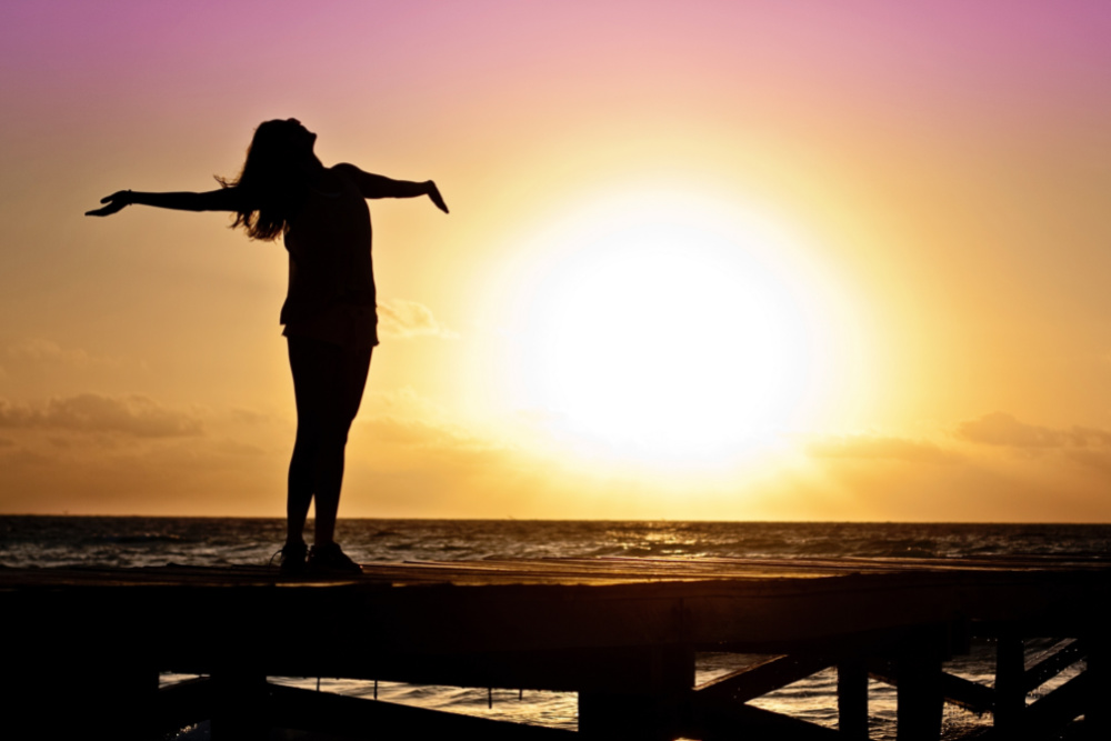 Happy woman in sunset. How I Put My Mastocytosis into Remission